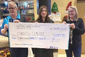 Ken Tjensvold, president of the Fraternal Order of Eagles in Abbotsford, and Tanya Oakes (right) present a donation of almost $5,100 to Maren Kroeker of Cyrus Centre. (Submitted photo)
